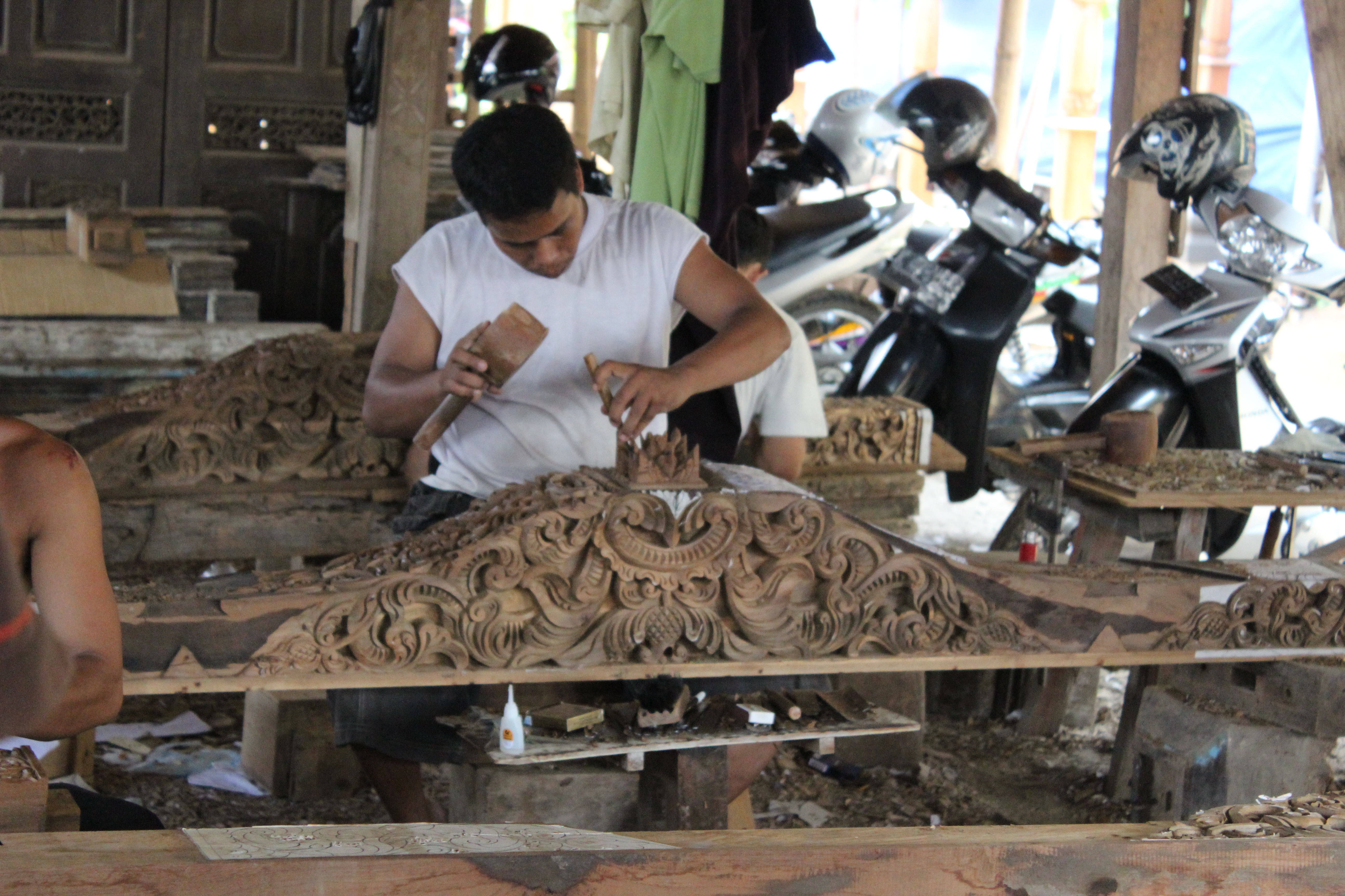 Maker completing a detailed timber carving
