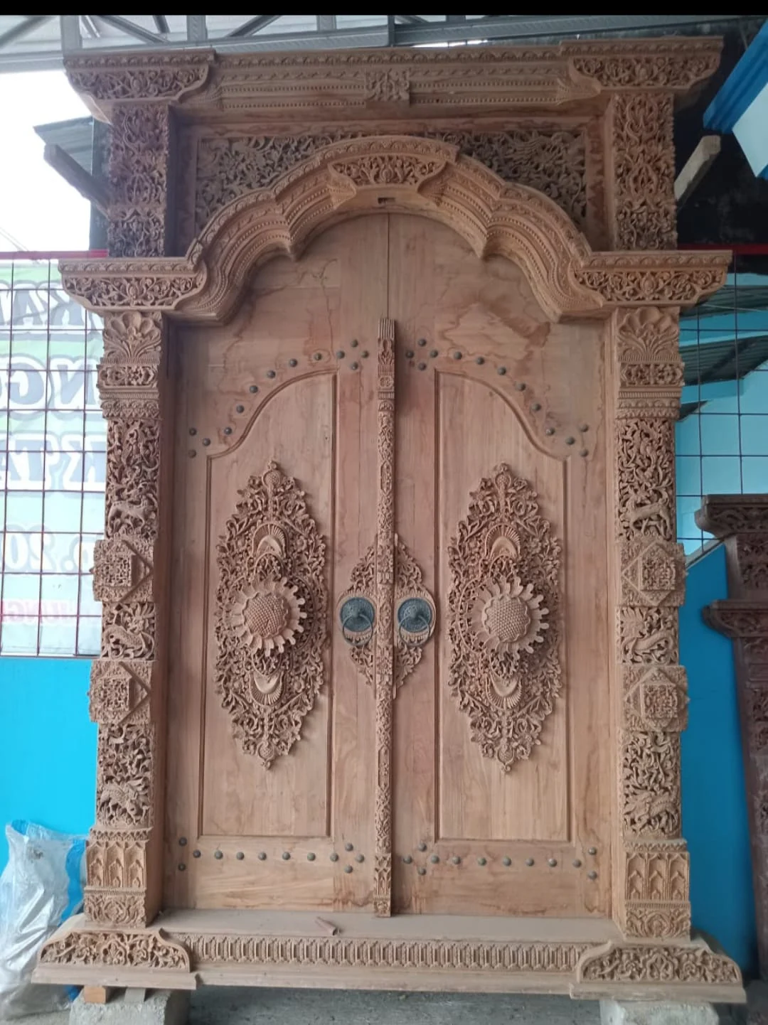 Ornate carved double door in the Tanarupa portfolio