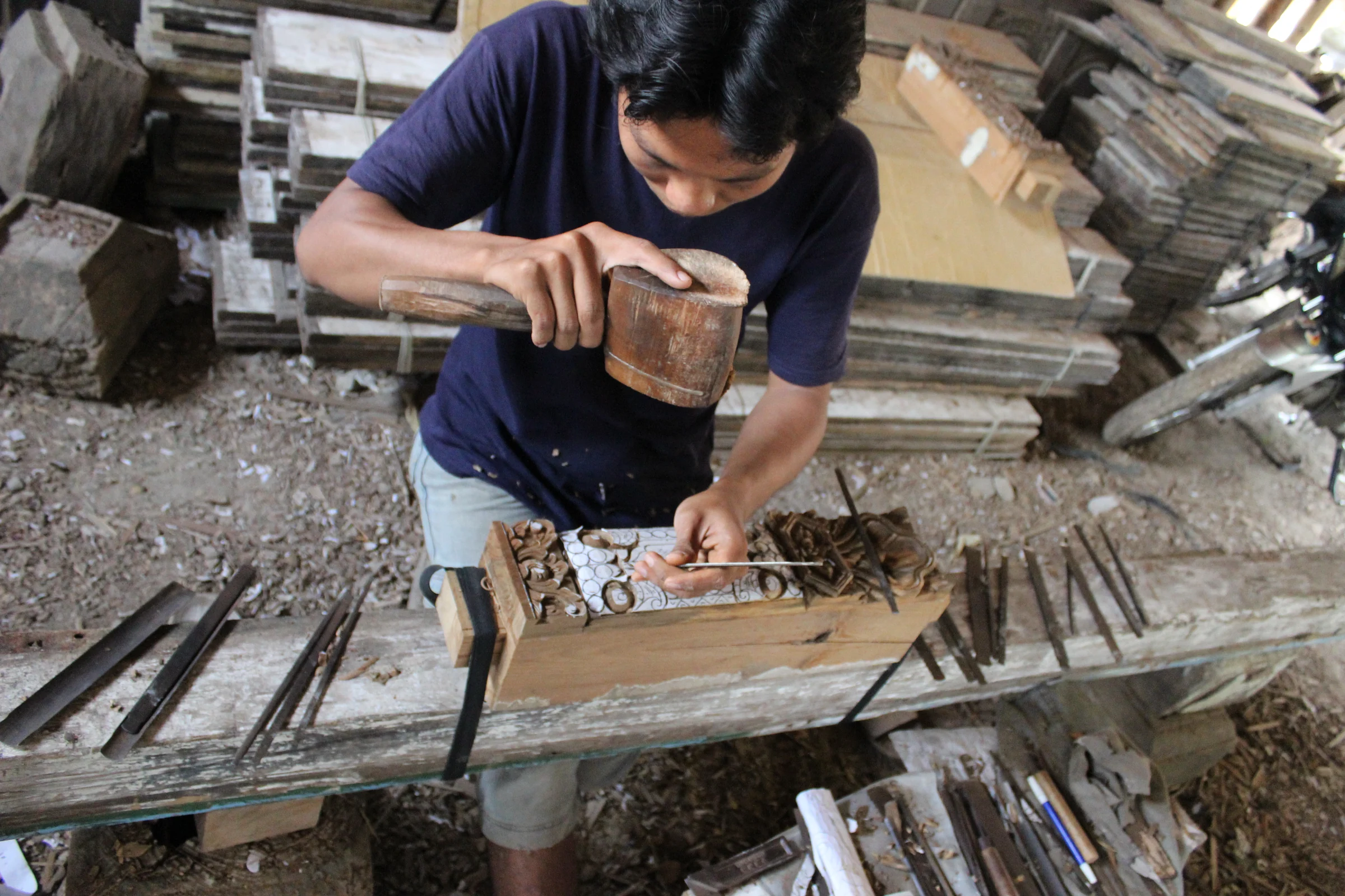 Artisan carving timber in the Tanarupa portfolio